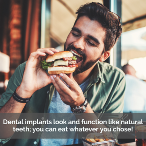 Man eating a hamburger. Caption: Dental implants look and function like natural teeth; you can eat whatever you choose!