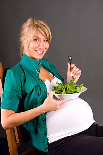 Pregnant woman eating a salad