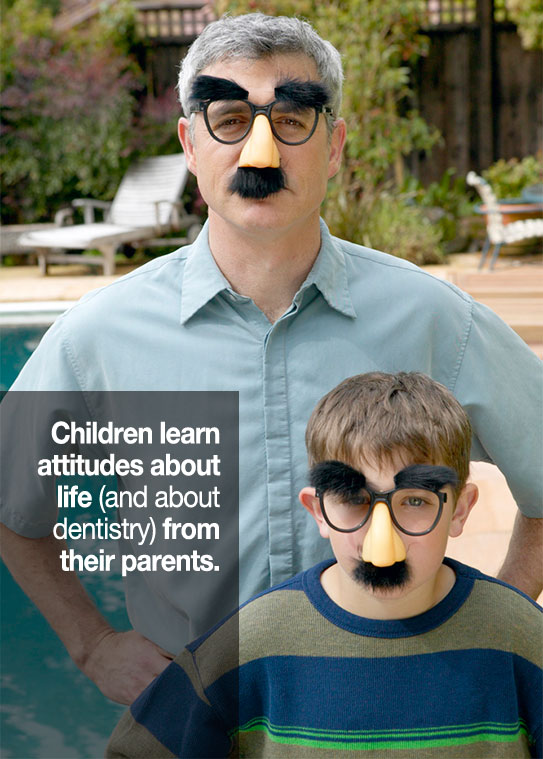 father and son wearing funny glasses with nose and mustache