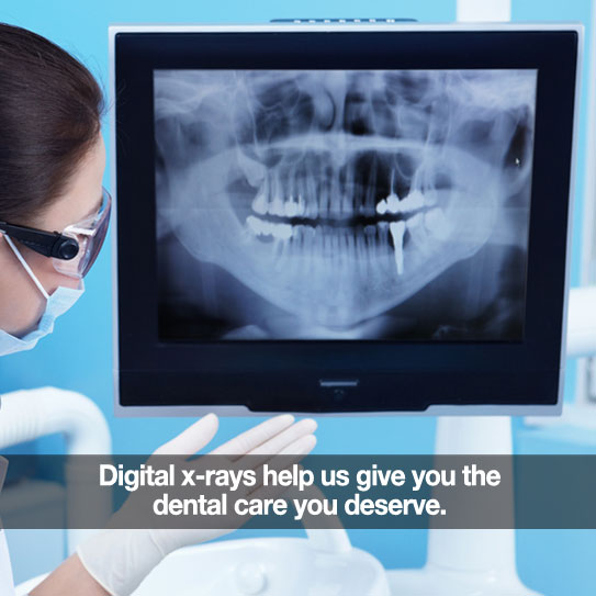 Dentist looking at digital X-rays of teeth