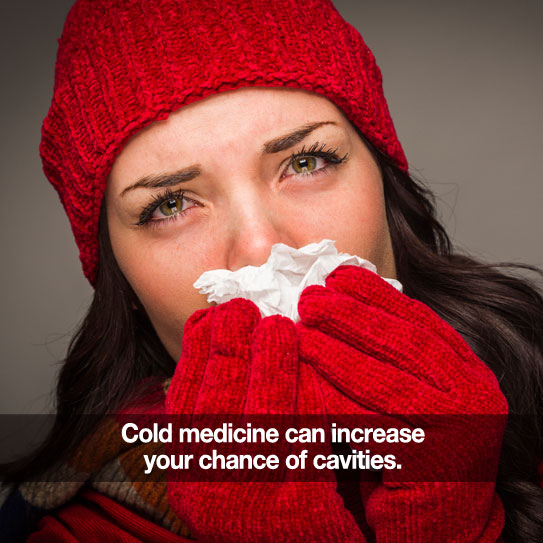 Woman with a Kleenex, hat, and gloves. Caption: Cold medicine can increase your chance of cavities.