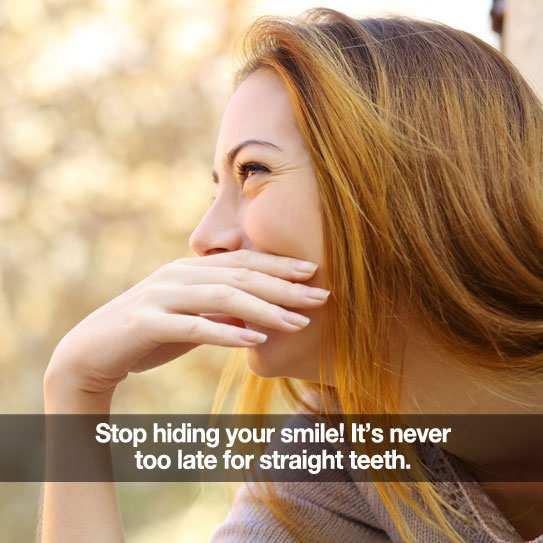 Young woman covering her smile. Caption: Stop hiding your smile! It's never too late for straight teeth.