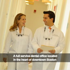 Two dentists walking down a hall. Caption: A full service dental office in downtown Boston.