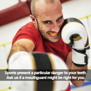 Man boxing toward the camera wearing a mouthguard