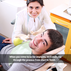 Male patient in dental chair, female dentist