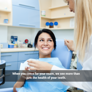 Female dental patient in dental chair smiling