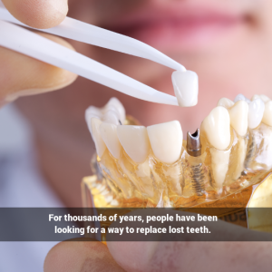 Dentist placing dental implant in model of a jaw