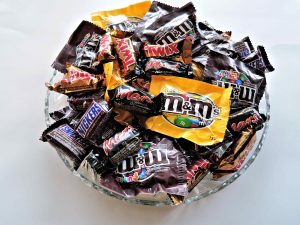 Assorted Halloween candy in a clear bowl