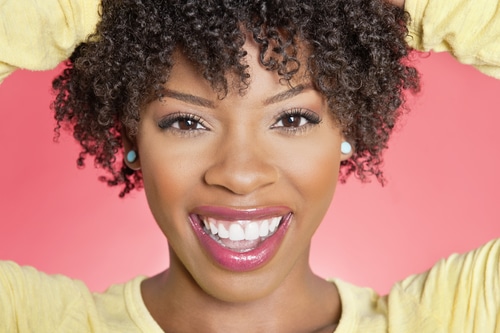 Black woman after gum whitening treatment in Boston