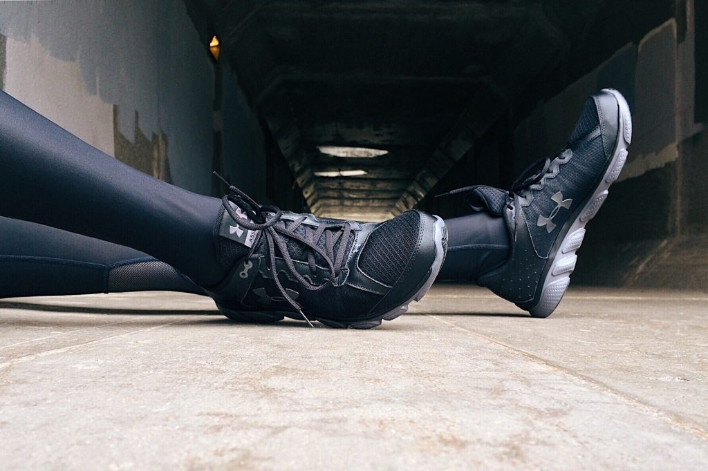 Close up of a runners legs and black running shoes 