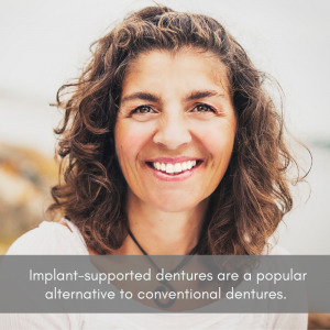 Woman smiling with perfect looking dentures.