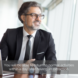 Man at the office smiling while looking out the window