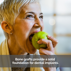 Bone grafting for solid teeth: A woman confidently takes a bite out of a green apple.