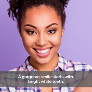 A woman smiles after teeth whitening procedure.