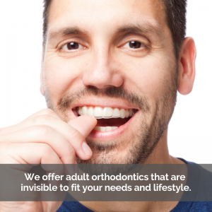 Man with Invisalign aligners smiling.