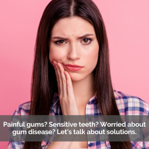 A women worries about gum disease while holding her cheek in pain.