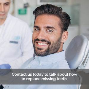 Man sits in dental chair to replace missing teeth.