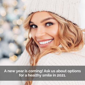 A beautiful woman smiles over her shoulder dressed in winter clothes showing her white teeth.