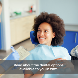 Ethnic woman sitting in a dental chair smiling.