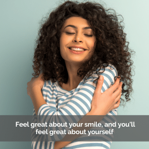 Young woman with beautiful white teeth hugging herself