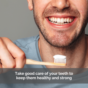 A man holding a toothbrush with toothpaste about to brush his teeth