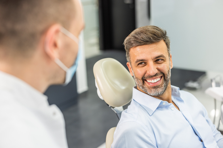 Man smile at the dentist after a dental cleaning