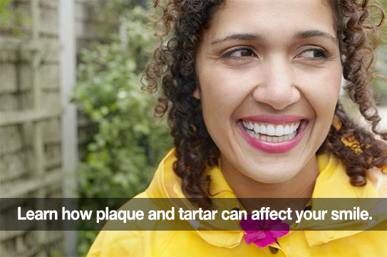 Woman smiling. Caption: Learn how plaque and tartar can affect your smile.