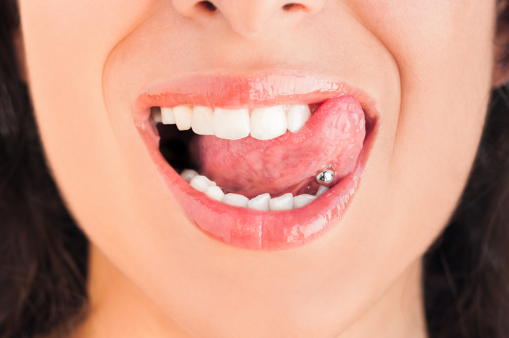 young woman with a tongue piercing
