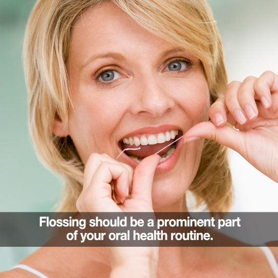 Woman flossing. Caption: Flossing should be a prominent part of your oral health routine