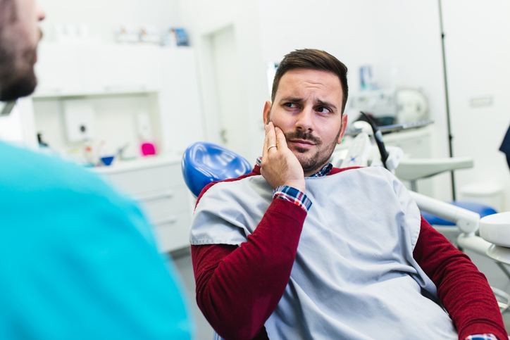 man having a dental emergency