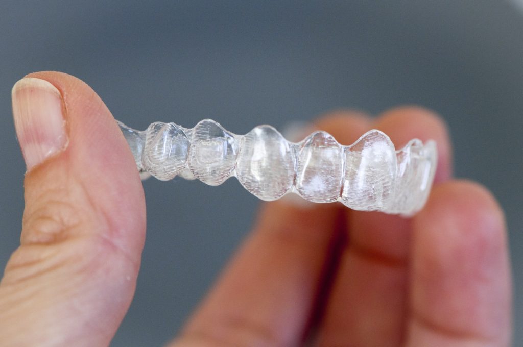 Closeup of Invisalign aligner in hand