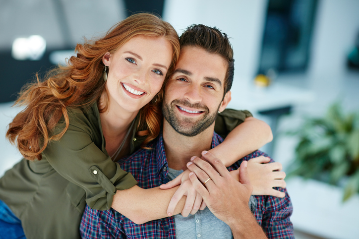 man and woman couple smiling confidently