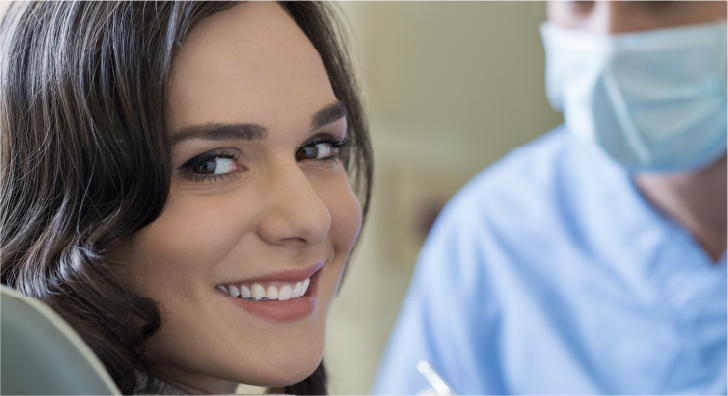 woman smiling in a dentist chair