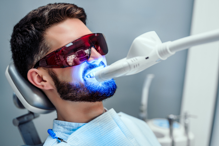 male getting an in-office teeth whitening treatment
