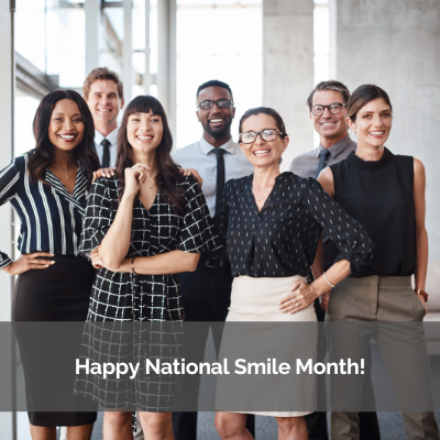 Happy National Smile Month! A group of people smiling in a building