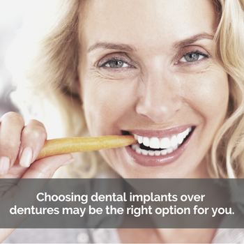 Woman biting a carrot: Choosing a dental implant over dentures may be the right option for you.