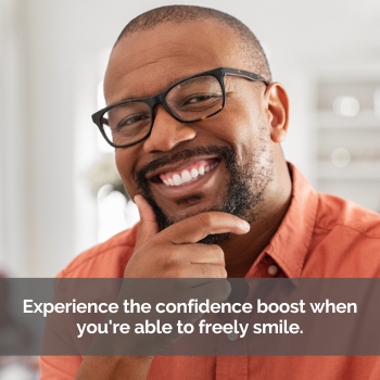 Man smiling. Caption: Experience the confidence boost when you're able to freely smile.