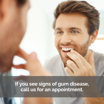 Man checking his teeth in mirror. Caption: Call if you see signs of gum disease