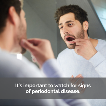 Man checking his teeth in the mirror. Caption: Watch for signs of periodontal disease