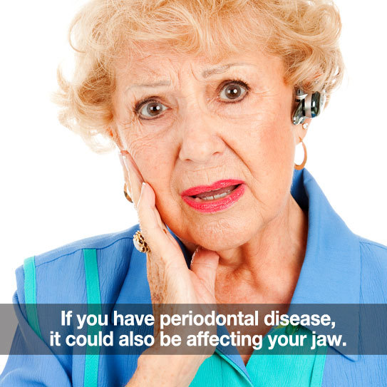 Elderly woman holding her jaw. Caption: Periodontal disease can affect you jaw.