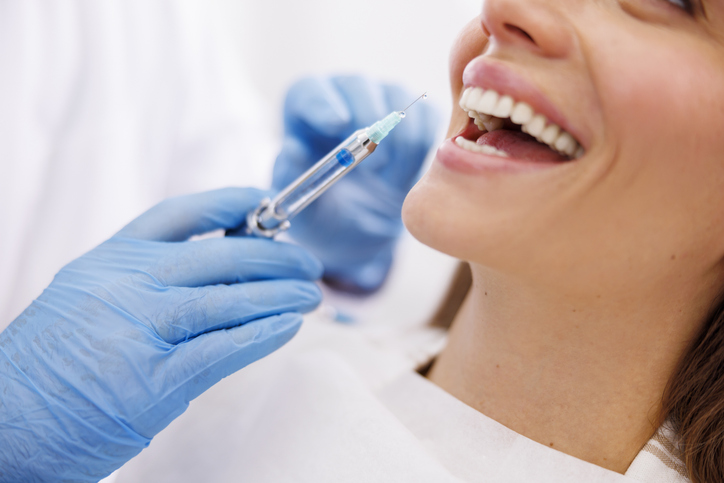 woman getting a cosmetic injection at a dental office.