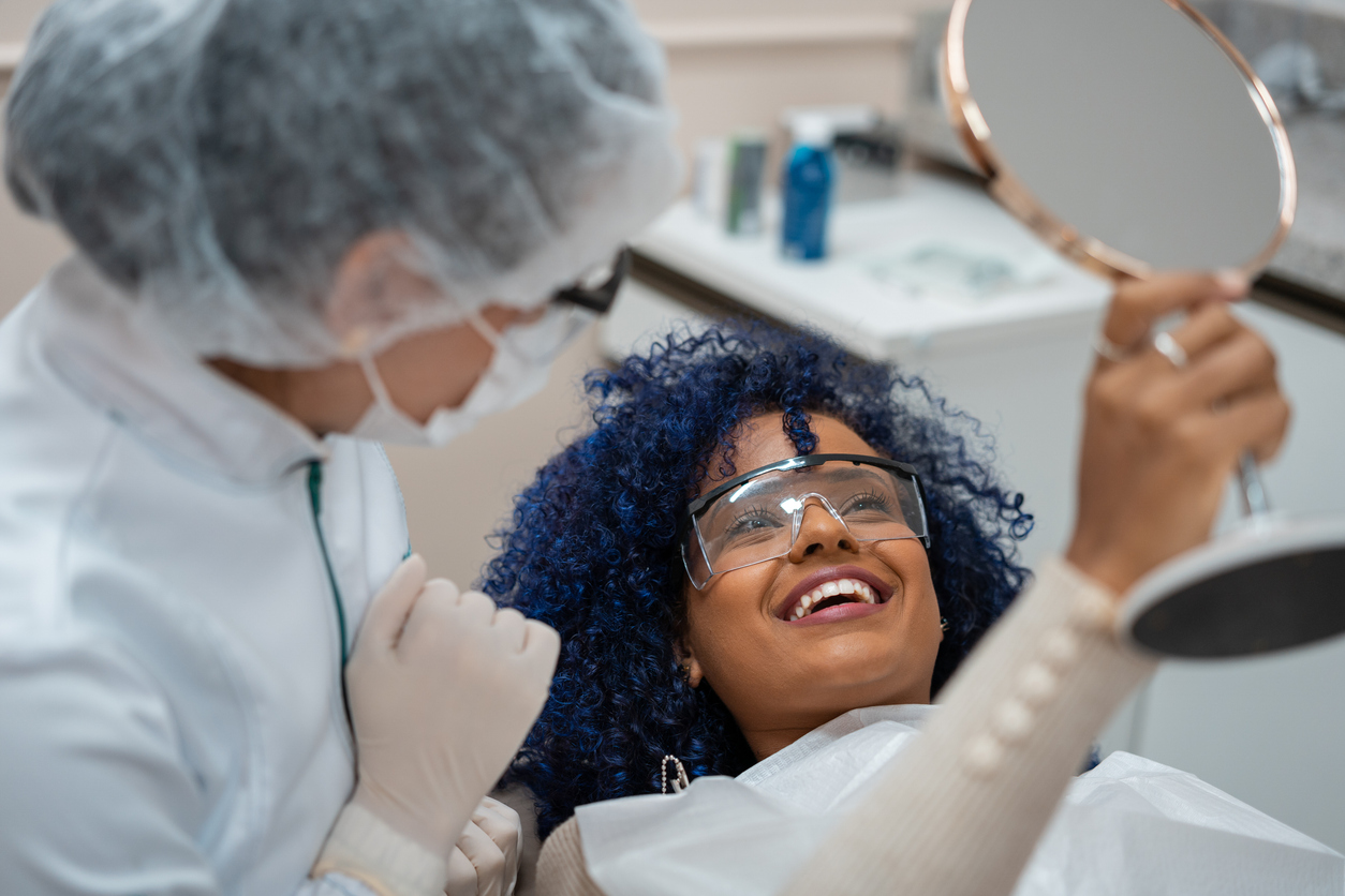 female patient smiling after cosmetic dental treatment