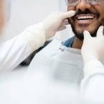 man getting his teeth checked by a dentist